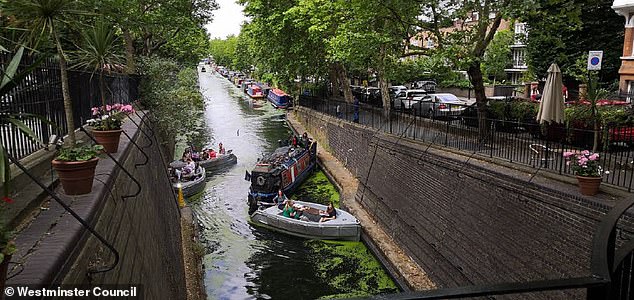 A group of boaters can be seen blocking the canal after getting in the way of a barge driver