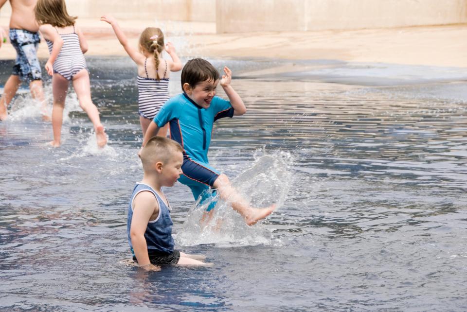 Children splashing in a water park.
