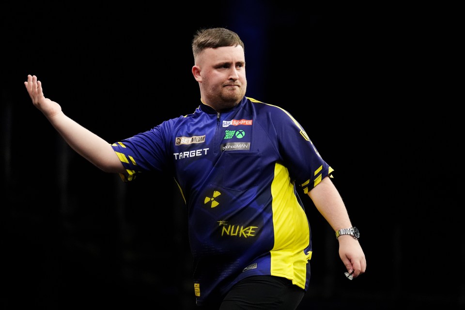 Luke Littler reacting during a darts match.