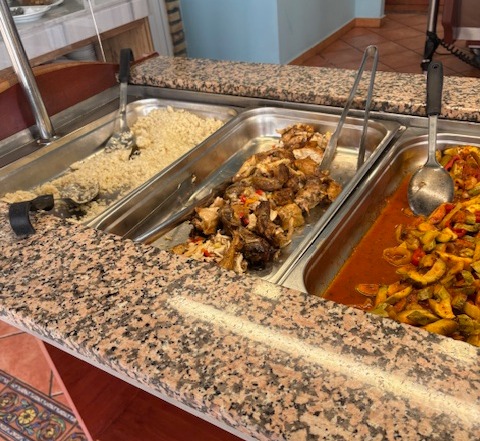 Hotel buffet with rice, chicken, and vegetables.