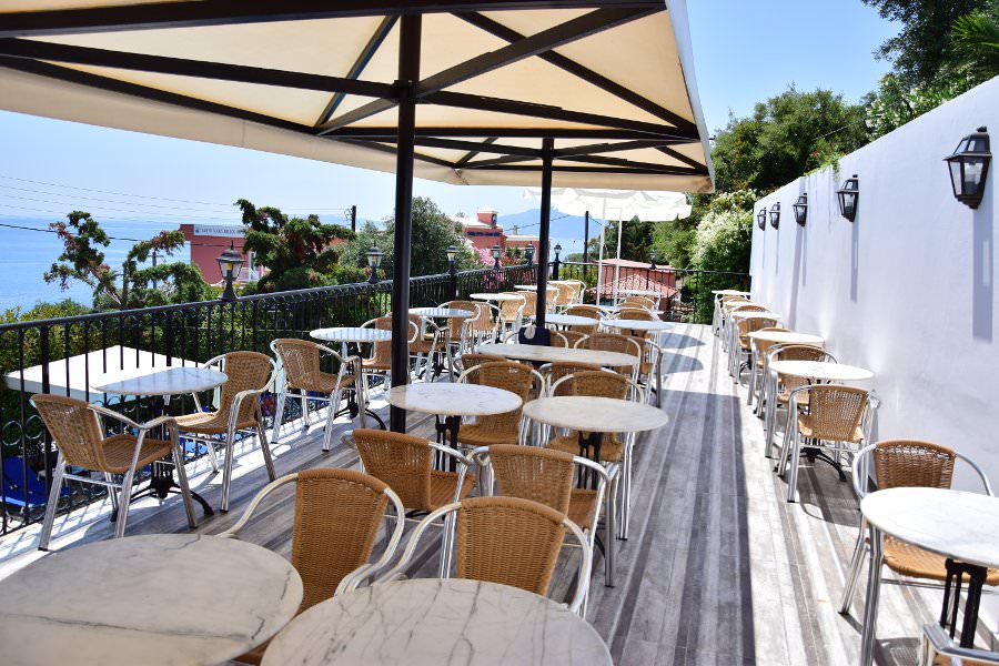 Outdoor patio seating area with ocean view.