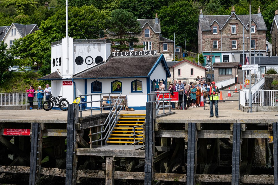 Passengers and crew at Kilcreggan pier in Scotland.