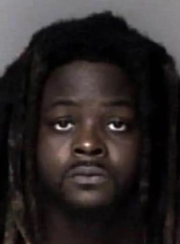 Mugshot of a man with long dreadlocks.