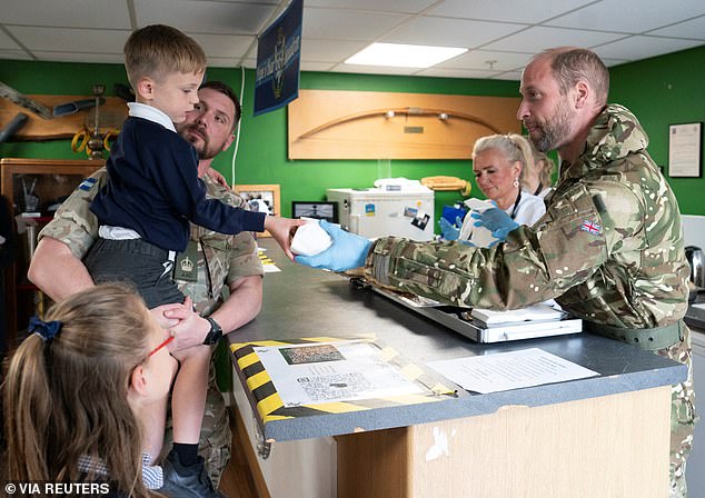 At the breakfast club (pictured), William asked troops and their families if they wanted a sausage or bacon bap, adding: 'It's making my mouth water'