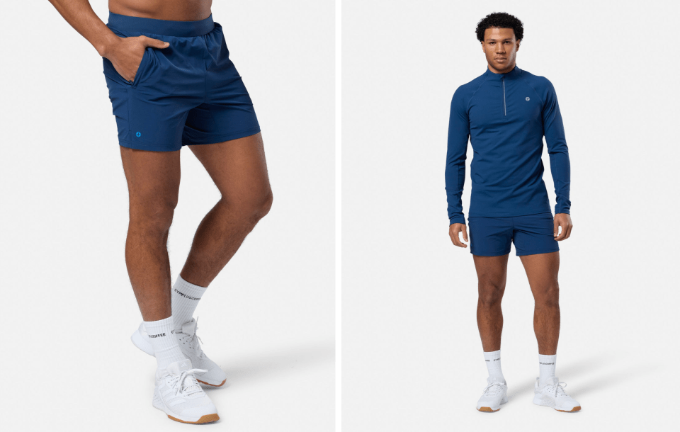 Man modeling navy blue athletic shorts and shirt.