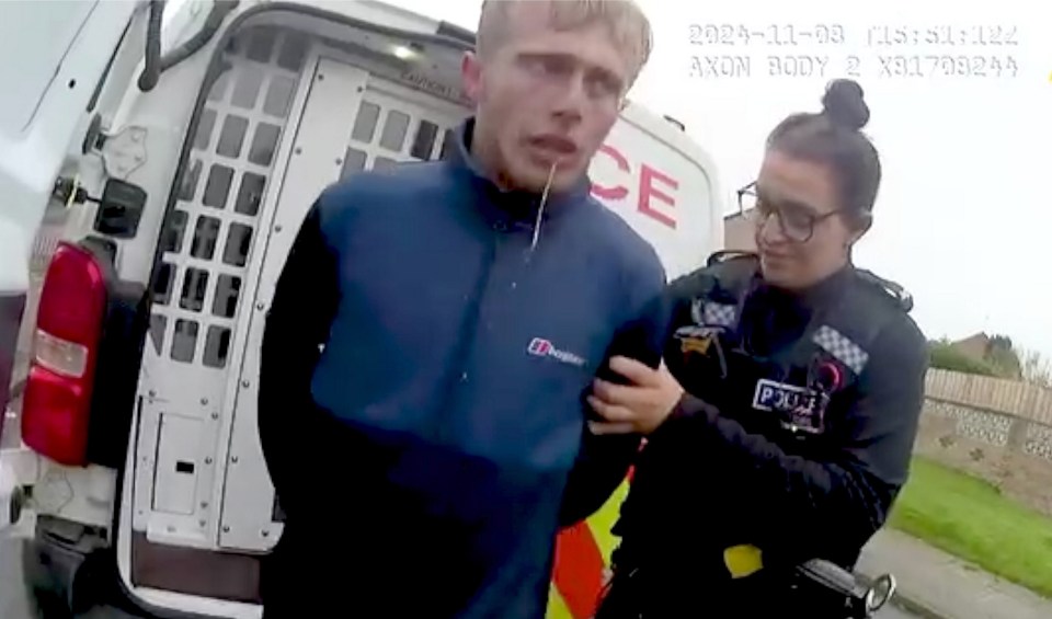 A police officer arresting a man.