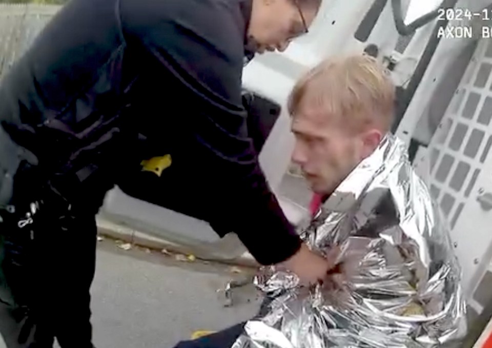 A man wrapped in a thermal blanket after a police chase.