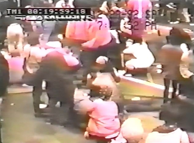 Victims are seen lying on the floor, with friends desperately trying to save them