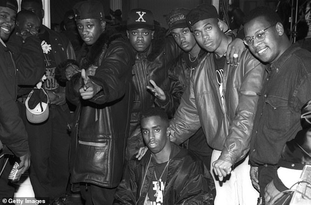 Combs (pictured front center) with members of the R&B group Jodeci, Mr. Cee and Andrew Harrell at the Def Jam Records Christmas party in December 1991