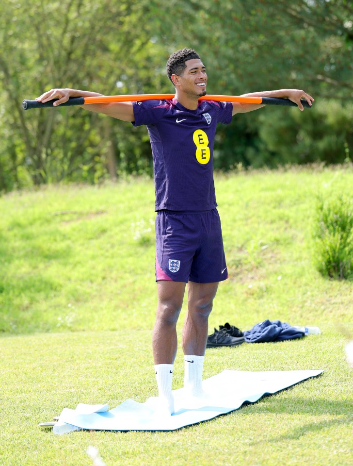 Jude Bellingham stretching during an England team training session.