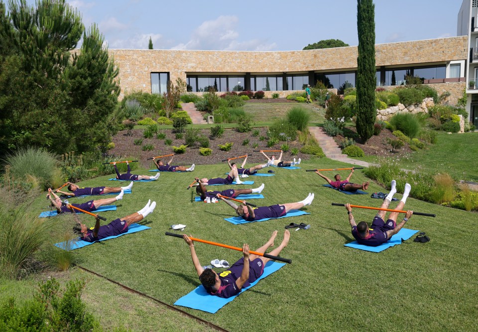 England soccer players stretching outdoors.