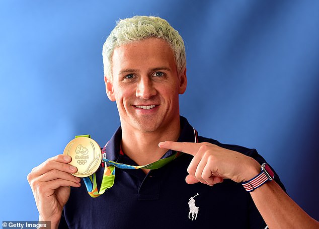 Lochte poses with his gold medal from the 2016 Olympics, where he medaled in the 4×200m freestyle relay