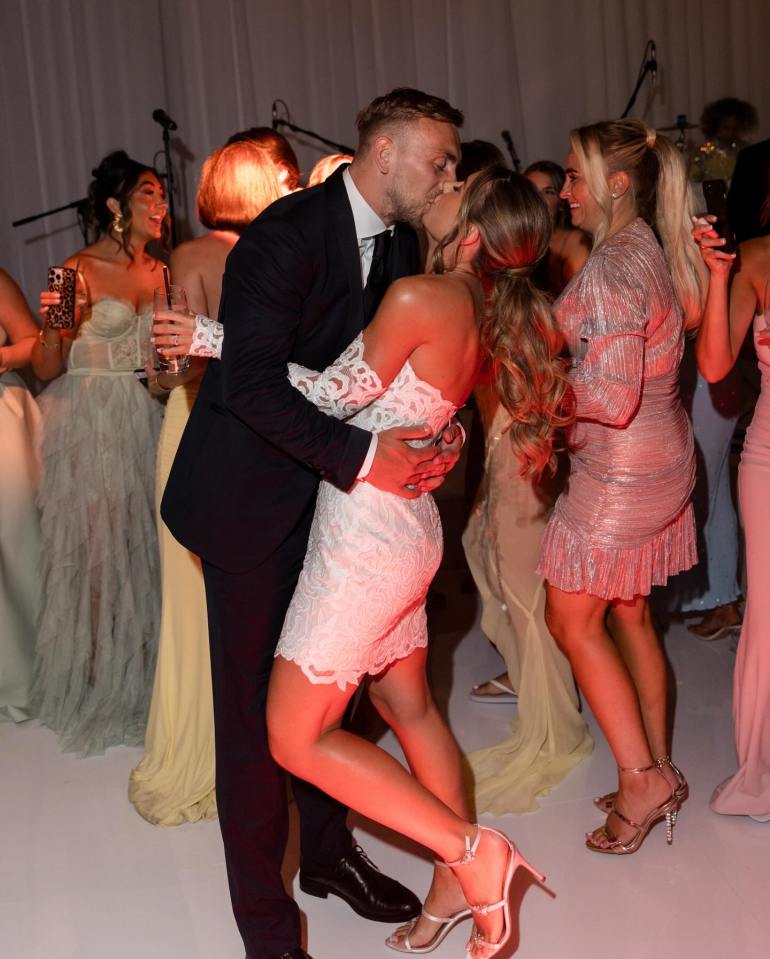 Couple kissing at wedding reception.