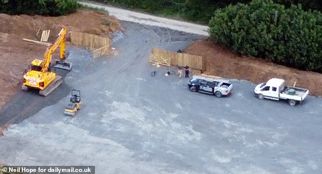 When MailOnline visited the location on Wednesday afternoon, a number of men could be seen working at it, using an industrial excavator to carve away ground and roller to flatten it