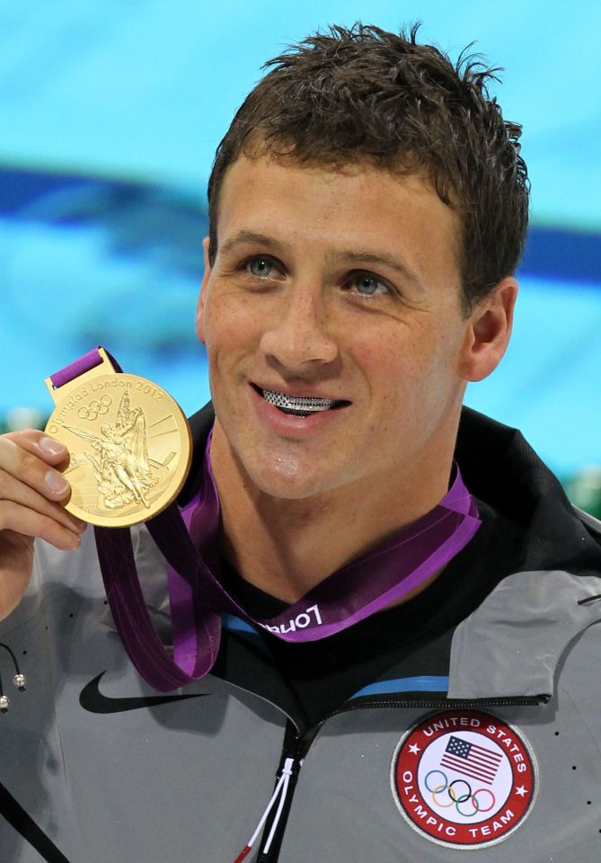 Ryan Lochte holding a gold medal.
