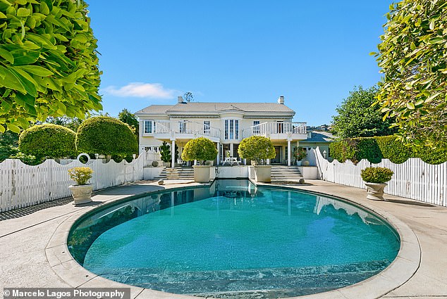 The stunning home boasts an array of amenities, including a pool and pool house
