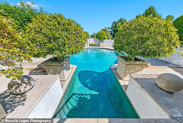 Various potted plants surround the pool