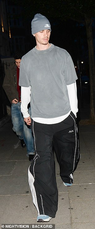 The model opted for a faded grey T-shirt over a white long-sleeved top