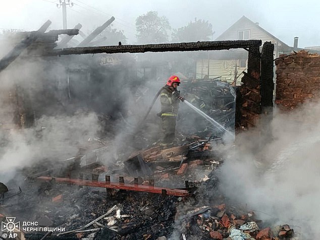 Firefighters put out the fire following Russia's overnight drone attack in the Pryluky, Chernihiv region