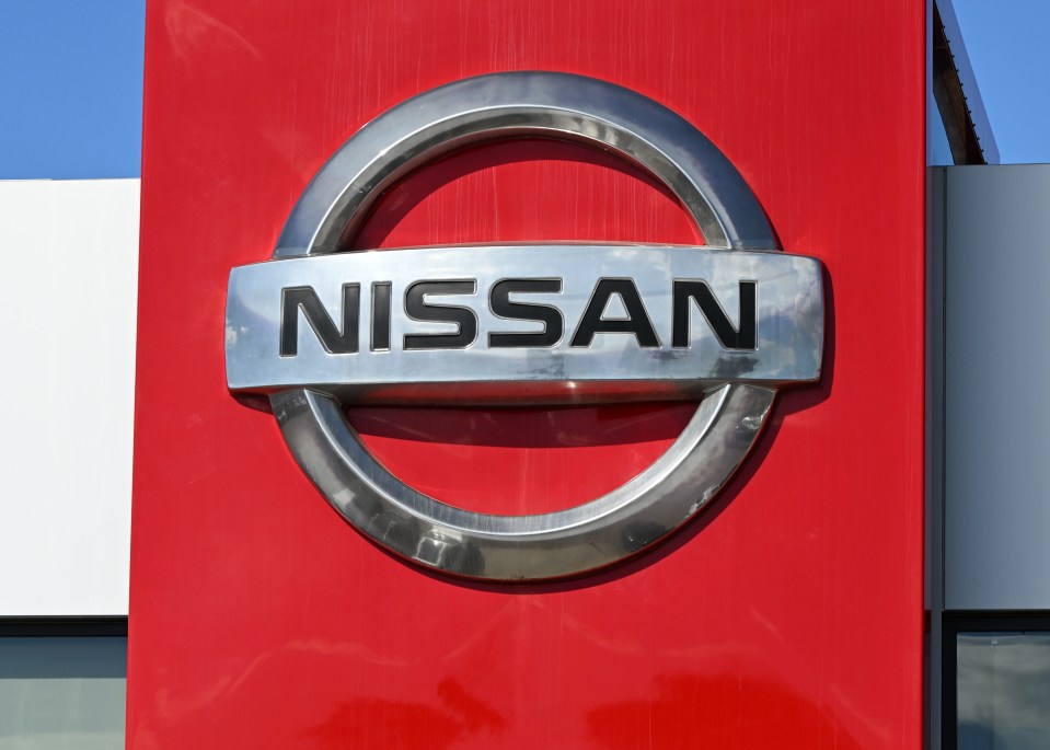 Nissan logo on a red wall.