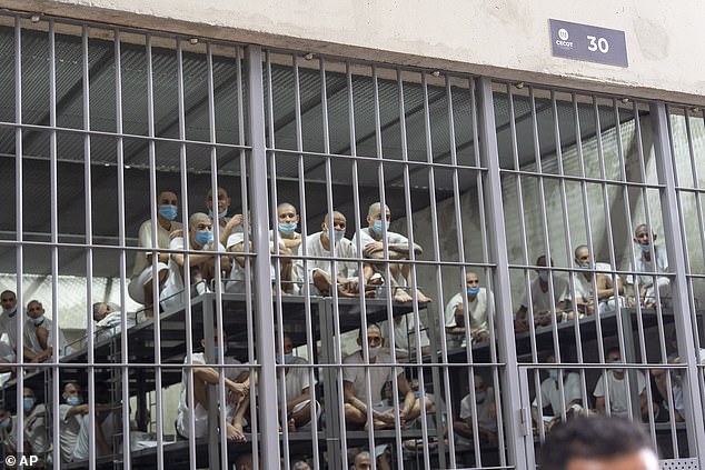 Prisoners look out of their cell as Homeland Security Secretary Kristi Noem tours the Terrorist Confinement Center in Tecoluca, El Salvador