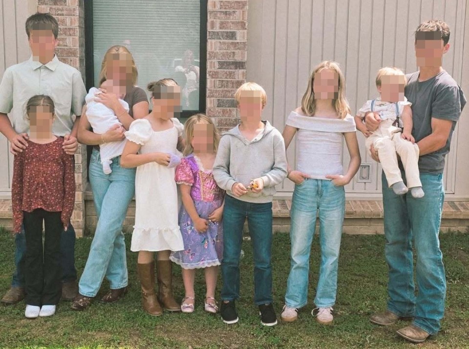 Family photo of ten children with two parents.