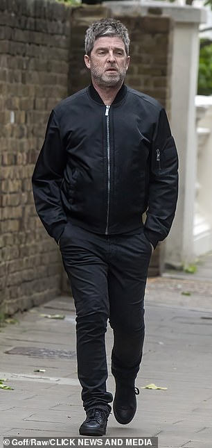 Noel dressed down in a black bomber jacket and matching jeans and trainers for rehearsals