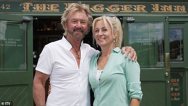 First-look pictures show Noel and Liz at work on their business, known as River Haven, with one depicting them outside its on-site pub, cheekily named The B***er Inn (pictured)