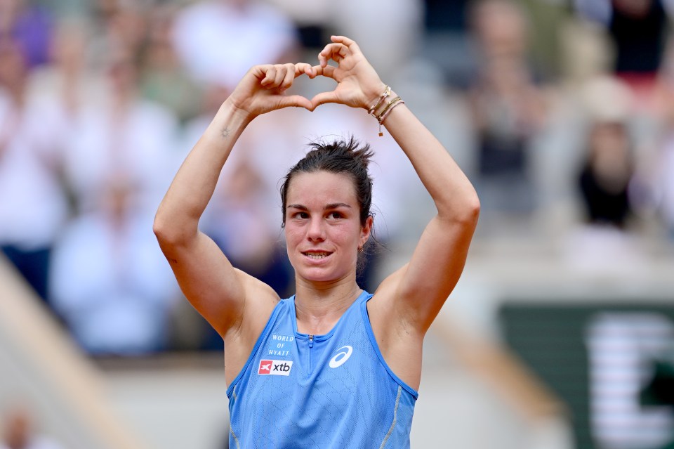 Lois Boisson making a heart shape with her hands after a tennis victory.