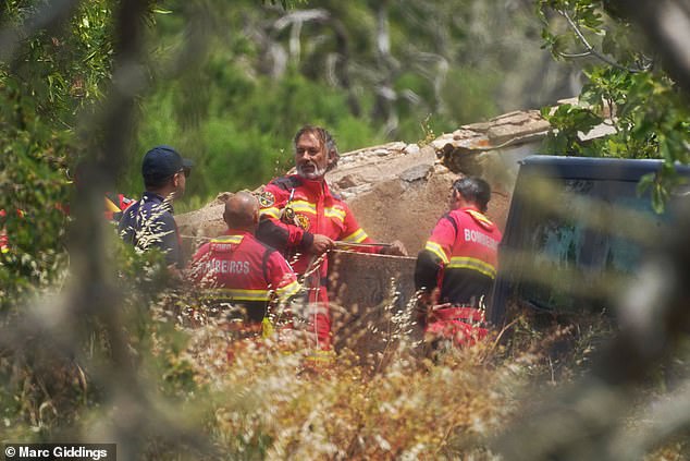 Search teams checking a well at a derelict and abandoned property to the west of Praia De Luz, Portugal
