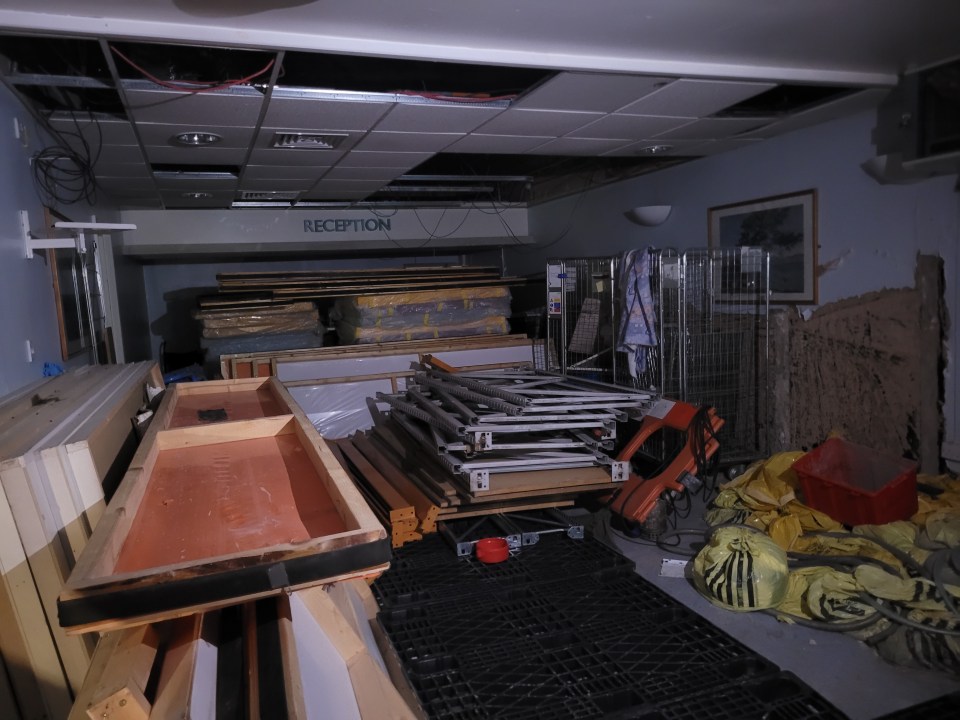 Damaged ceiling and discarded materials in an abandoned hospital clinic.