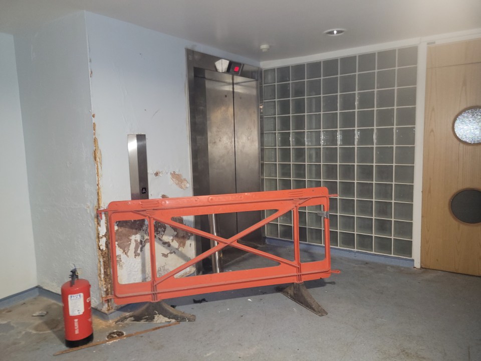 Out-of-order elevator in a dilapidated hospital hallway.