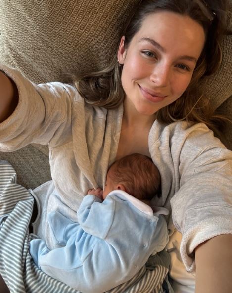 Woman breastfeeding newborn baby.