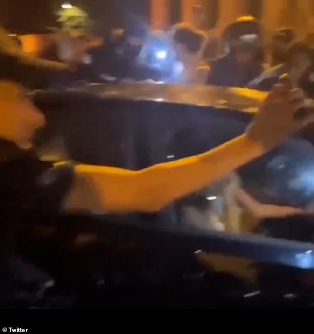 A huge crowd of men is seen taunting the young women in the horrifying footage