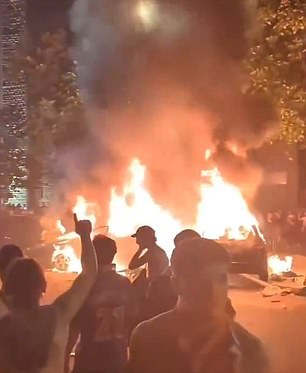 Gangs of people watched as cars were set on fire and burned in the streets of Paris