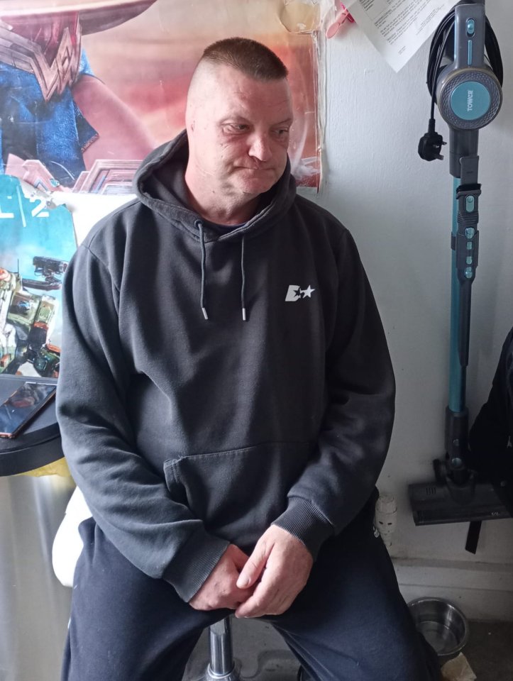 Man sitting, looking down, after a dog attack.