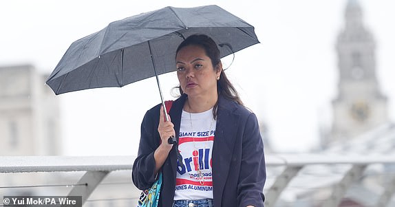 A woman with an umbrella walking along the Millennium Bridge, in London, during a rain shower. Changeable weather is forecast this week, with a chance of heavy rain and thunder hitting parts of the UK, the Met Office said. Picture date: Thursday June 5, 2025. PA Photo. See PA story WEATHER Wet. Photo credit should read: Yui Mok/PA Wire