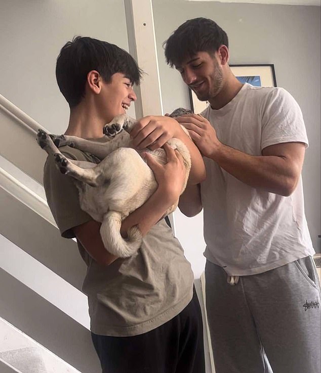 The family said they are increasingly concerned as to where their beloved dog might be. Pictured: Ozzie with Harry and older brother Peter, 19