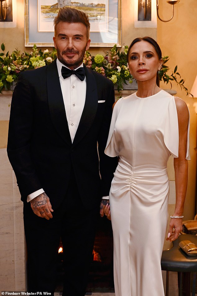 The tattooed ex-England star with his wife Victoria at a state dinner in celebration of Slow Food at King Charles's Gloucestershire estate