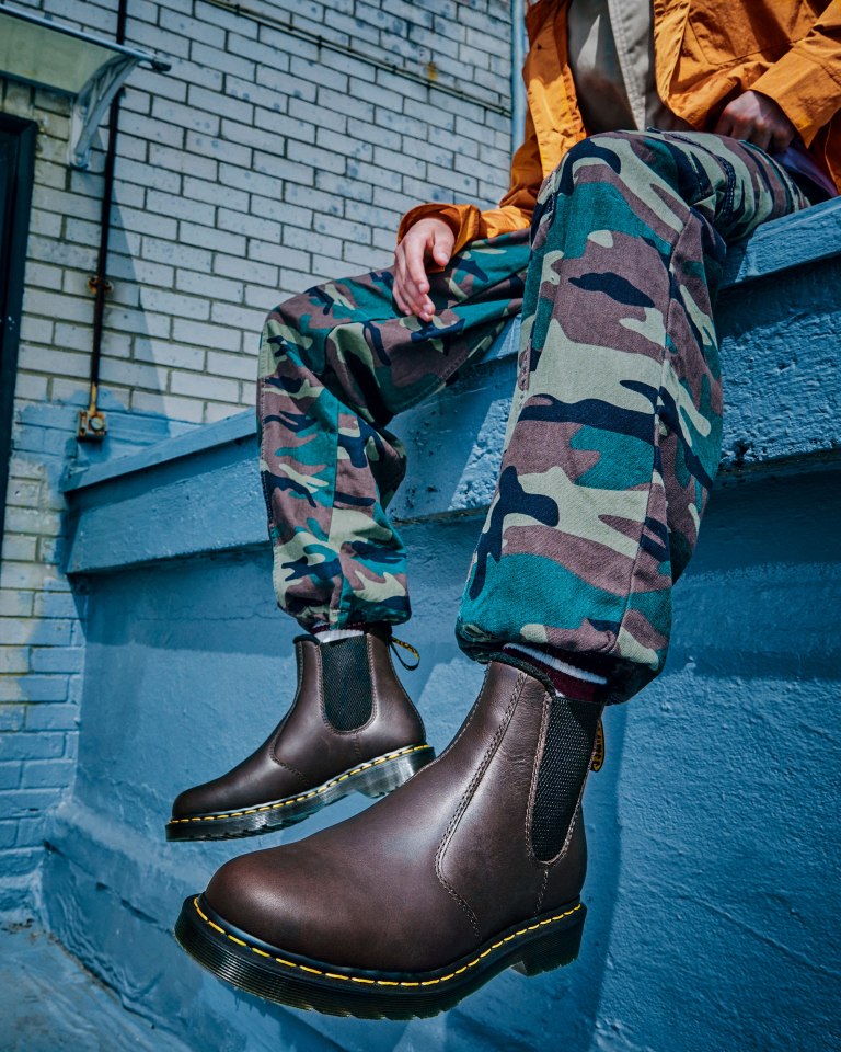 Person wearing Dr. Martens boots.