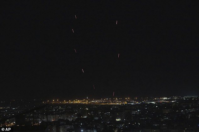 People fire live rounds into the air as a warning, following Israeli threats of an impending attack on Dahiyeh, a southern suburb of Beirut, Lebanon, Thursday, June 5, 2025