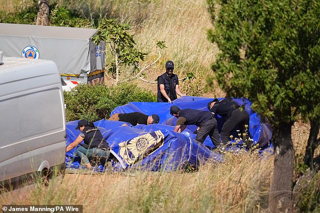Officers pack up a tent at the end of the day of searching at one of the base camps close to Praia De Luz, Portugal, where searches are being carried out by officers investigating the disappearance of Madeleine McCann