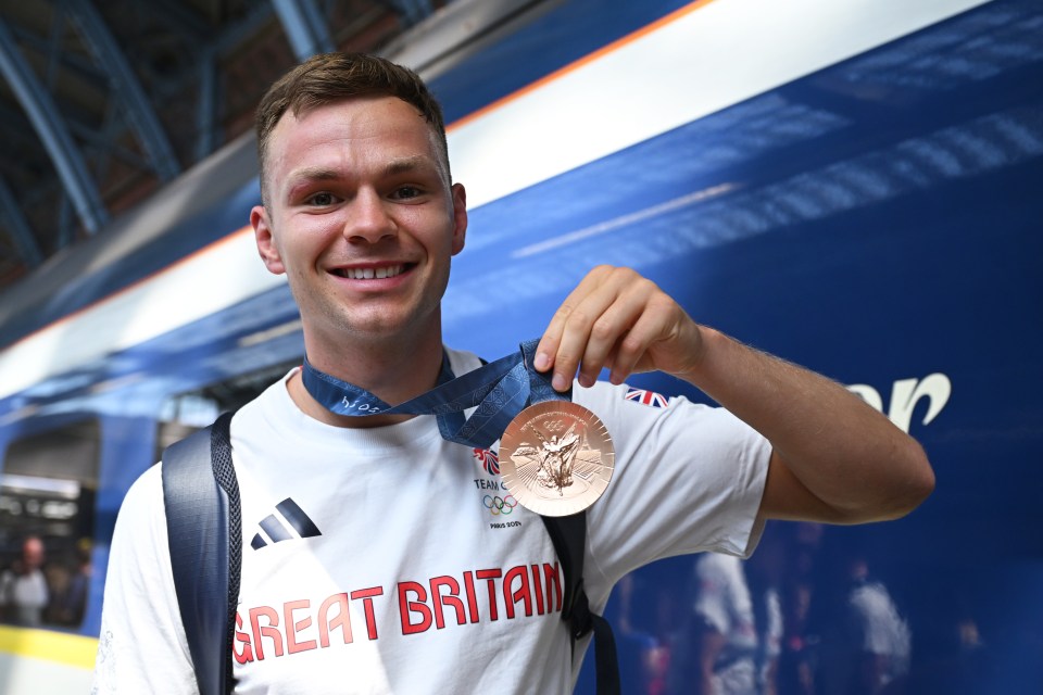 Boxer Lewis Richardson of Team GB shows off his bronze medal at St. Pancras Station.