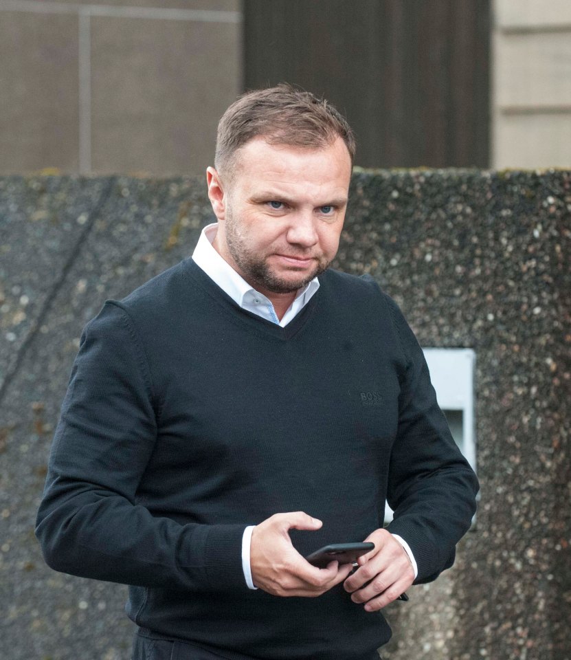 Eddie Lyons Jr. at Sheriff Court, looking at his phone.
