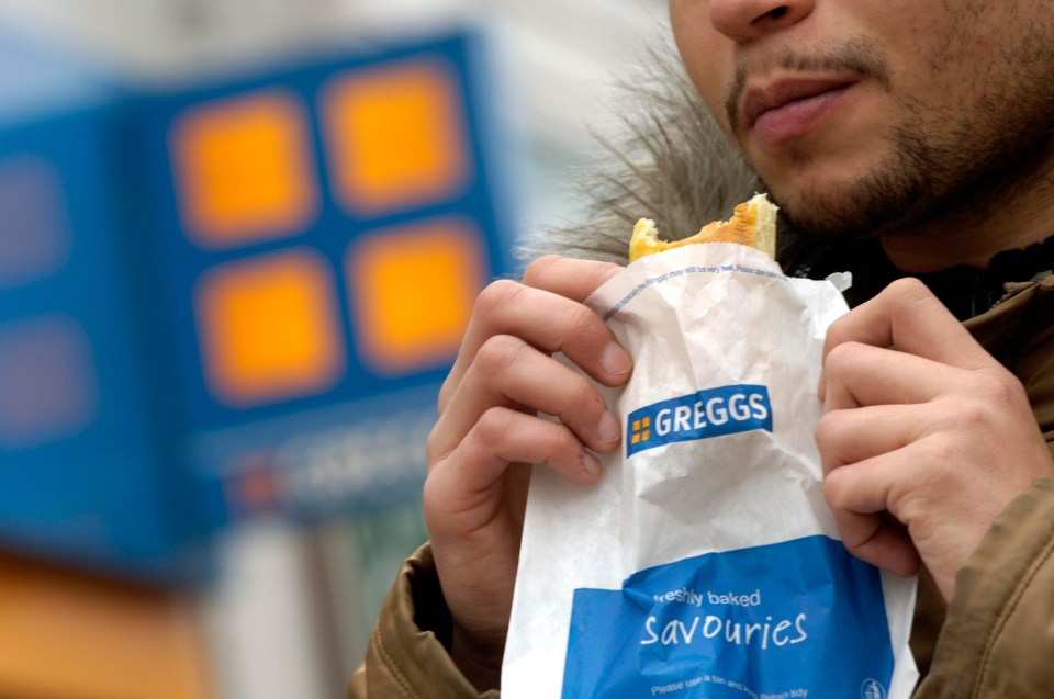Man eating a Greggs savourie.
