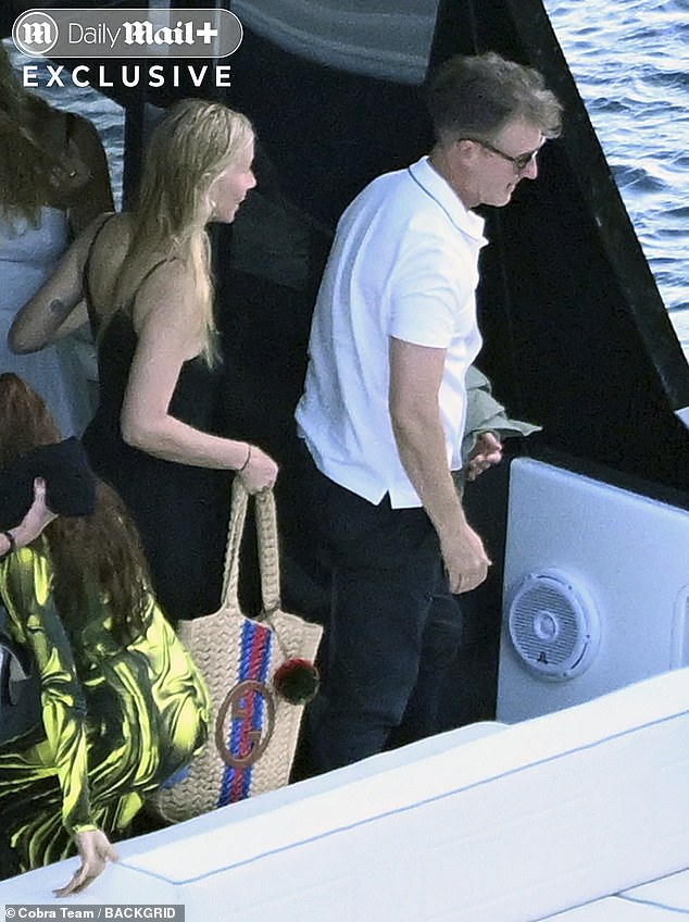 Paltrow accessorized with some hoop earrings and a classy gold necklace, and held a brown knit patterned purse on her shoulder