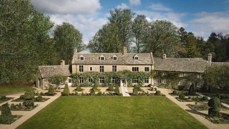 Aerial view of a five-bedroom Cotswolds house with gardens.