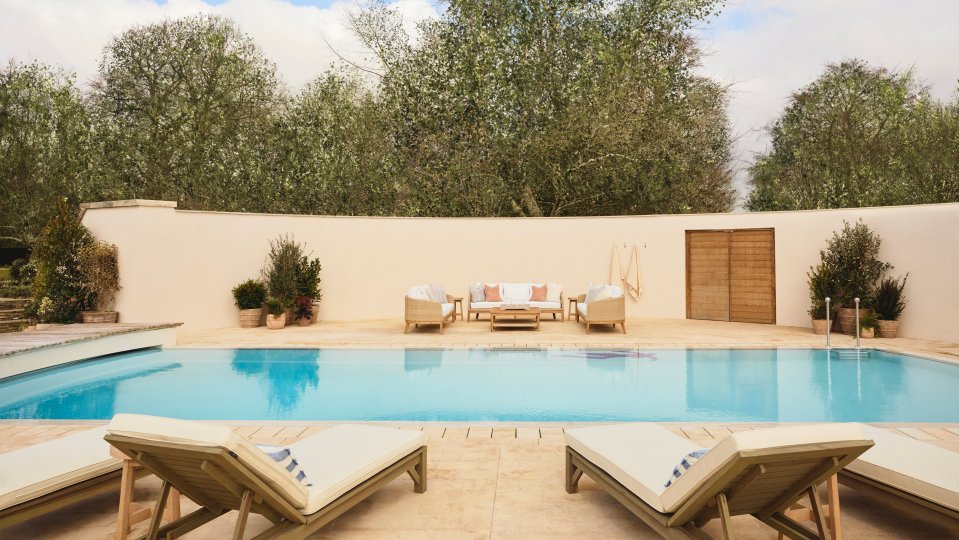 Luxury Cotswolds home with pool and outdoor seating.