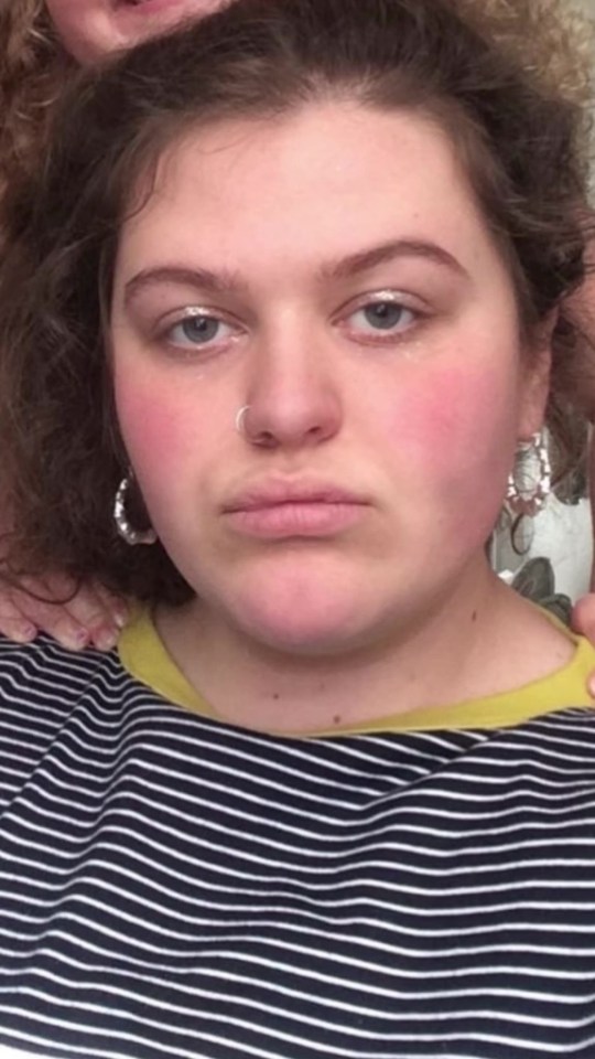 Close-up of a young woman wearing a striped shirt.