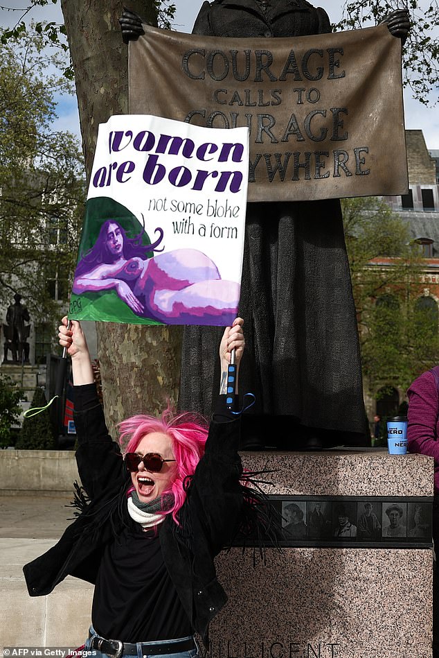Activists celebrate after hearing the outcome of the Supreme Court's ruling on how to define a 'woman'